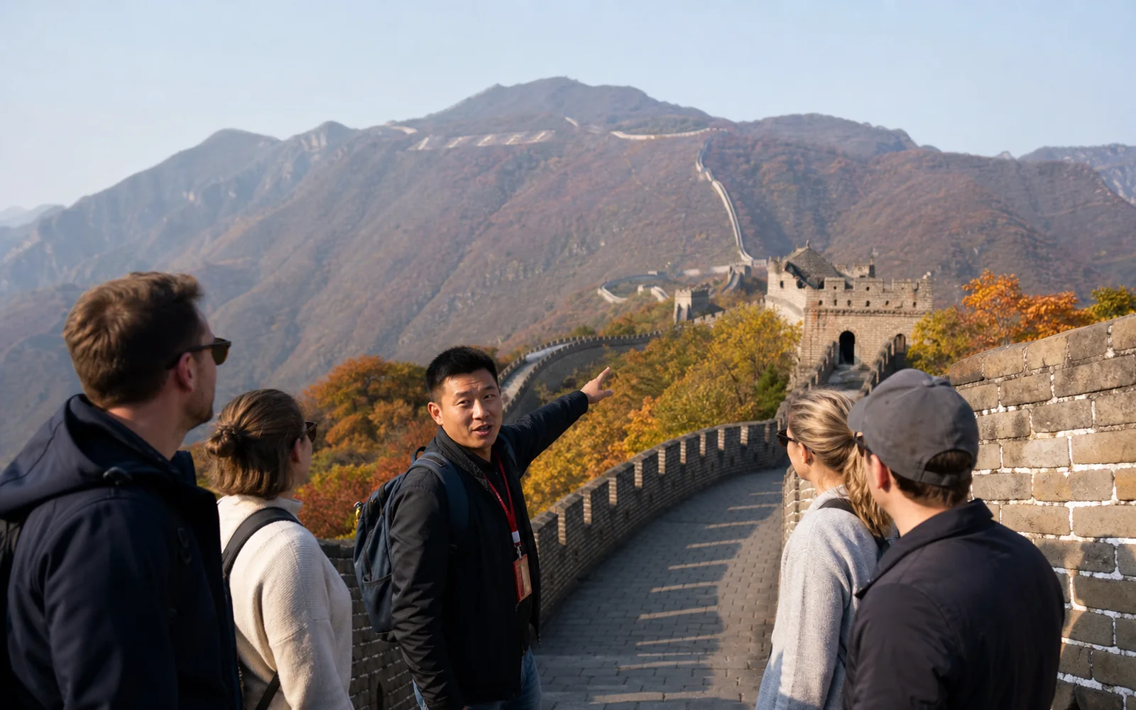 International travelers with a Beijing guide on the Great Wall in clear autumn light