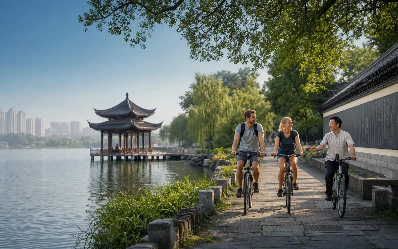 Changde featuring Liuye Lake, a lakeside pavilion, cycling travelers and a local guide