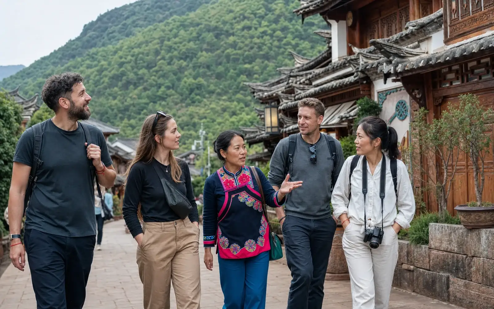 Travelers with a Yi local guide in Chuxiong old town with central Yunnan hills behind