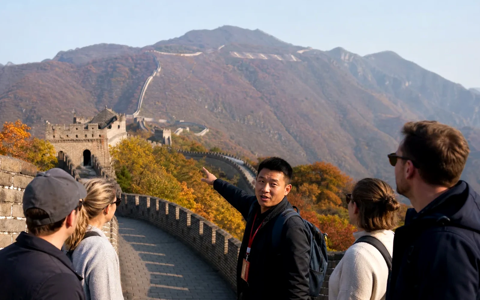 International travelers walking the Great Wall of China with a knowledgeable local guide