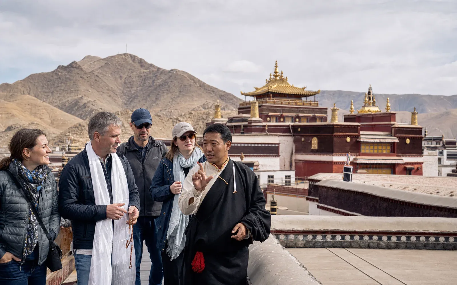Travelers with a Tibetan guide at Tashilhunpo Monastery in Shigatse