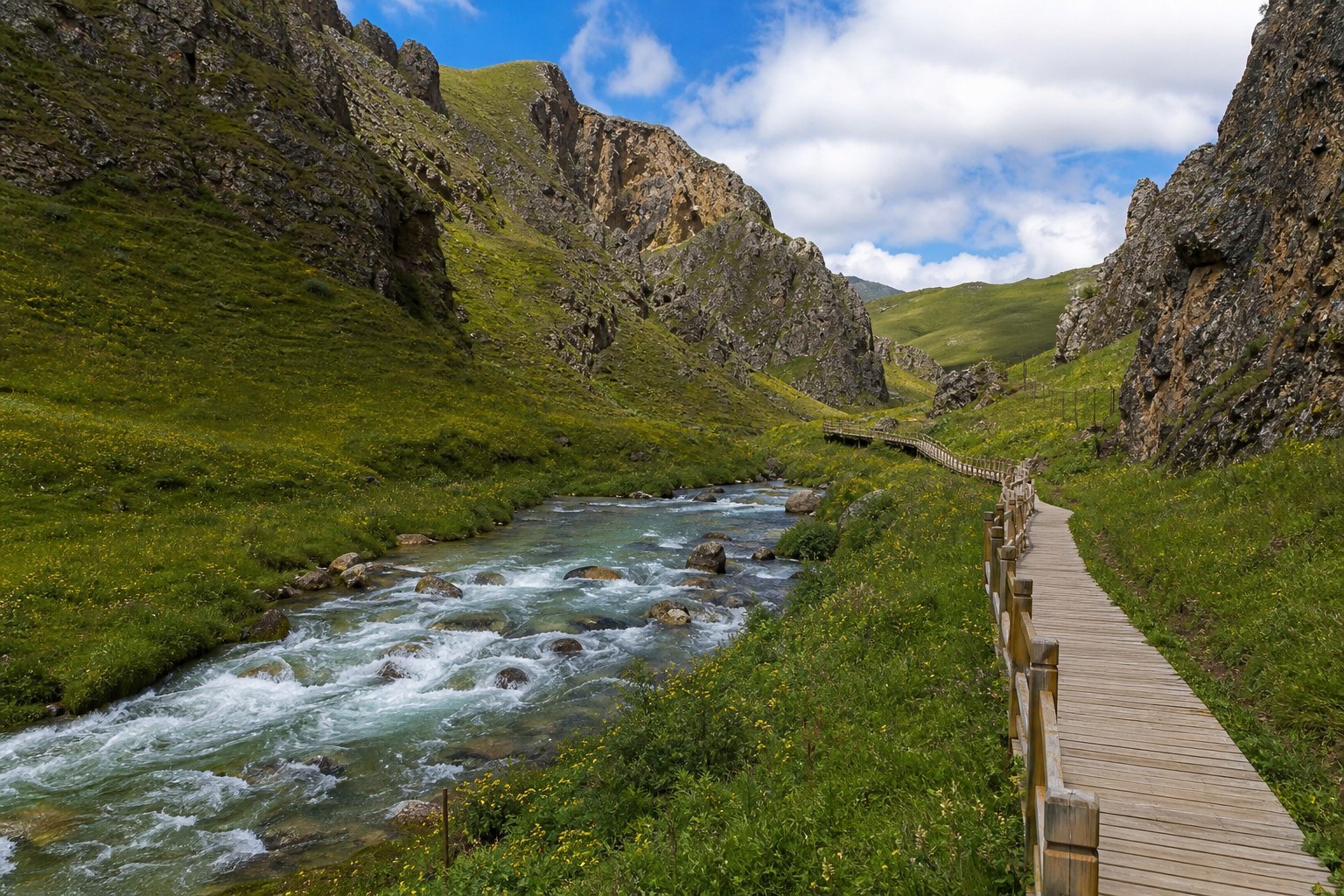 Clear stream winding through Namo Canyon between rugged cliffs and alpine meadow
