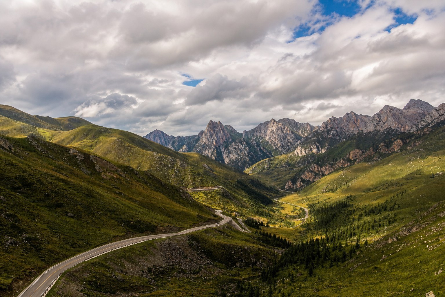 Jiangdie scenic highway winding through mountain passes toward Zhagana
