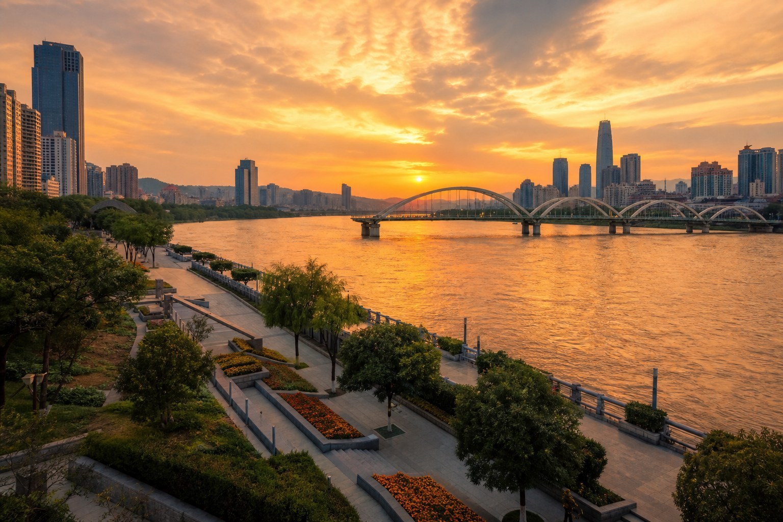 Lanzhou skyline and landscaped Yellow River waterfront at sunset