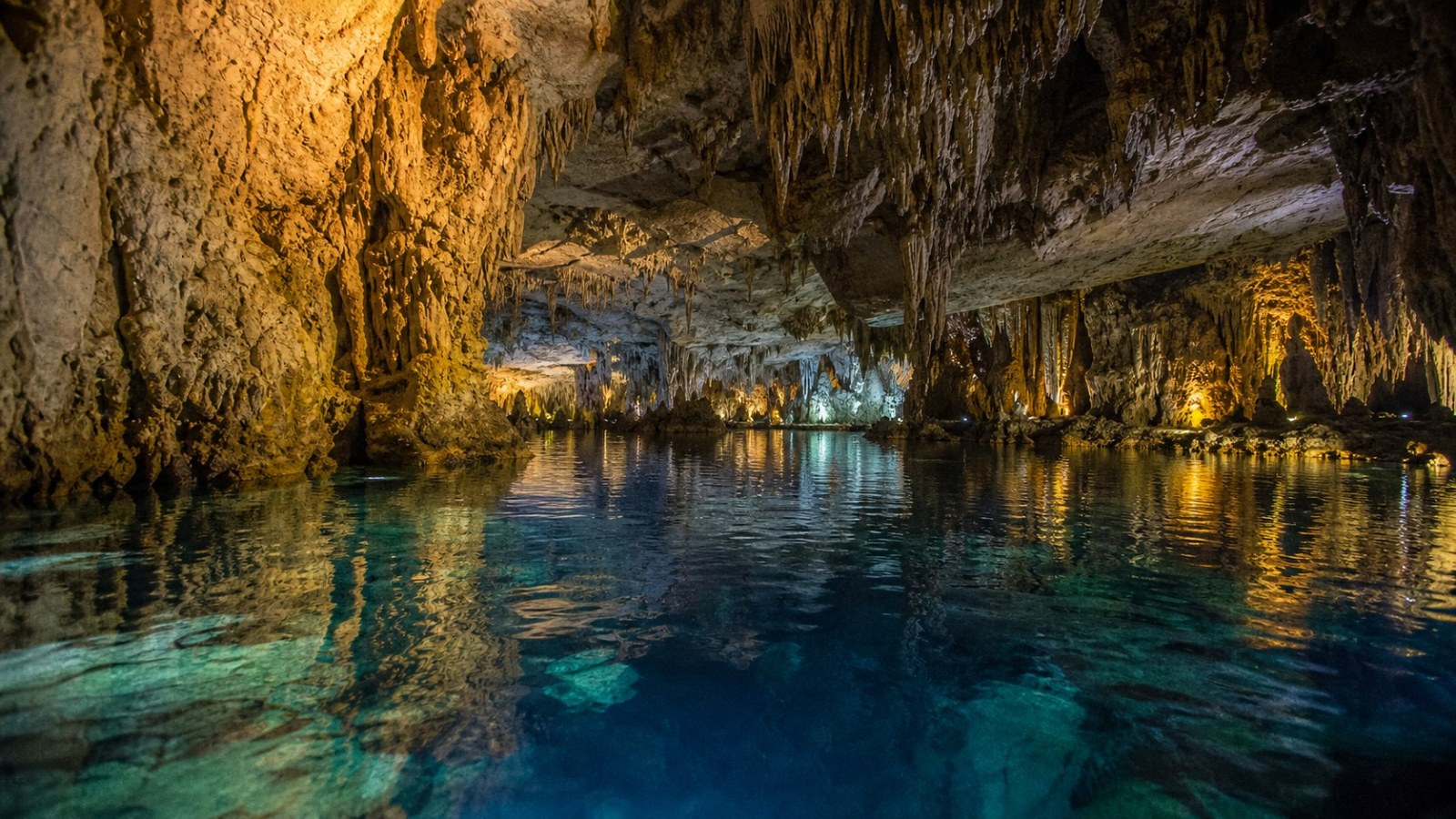 Illuminated underground river inside Benxi Water Cave