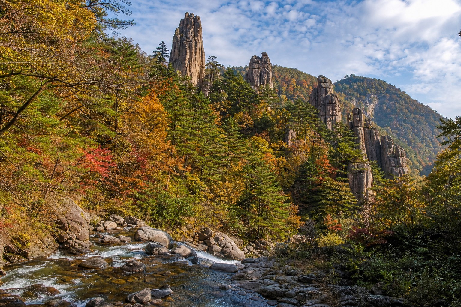 Tangwang granite formations rising from dense red pine forest in Yichun