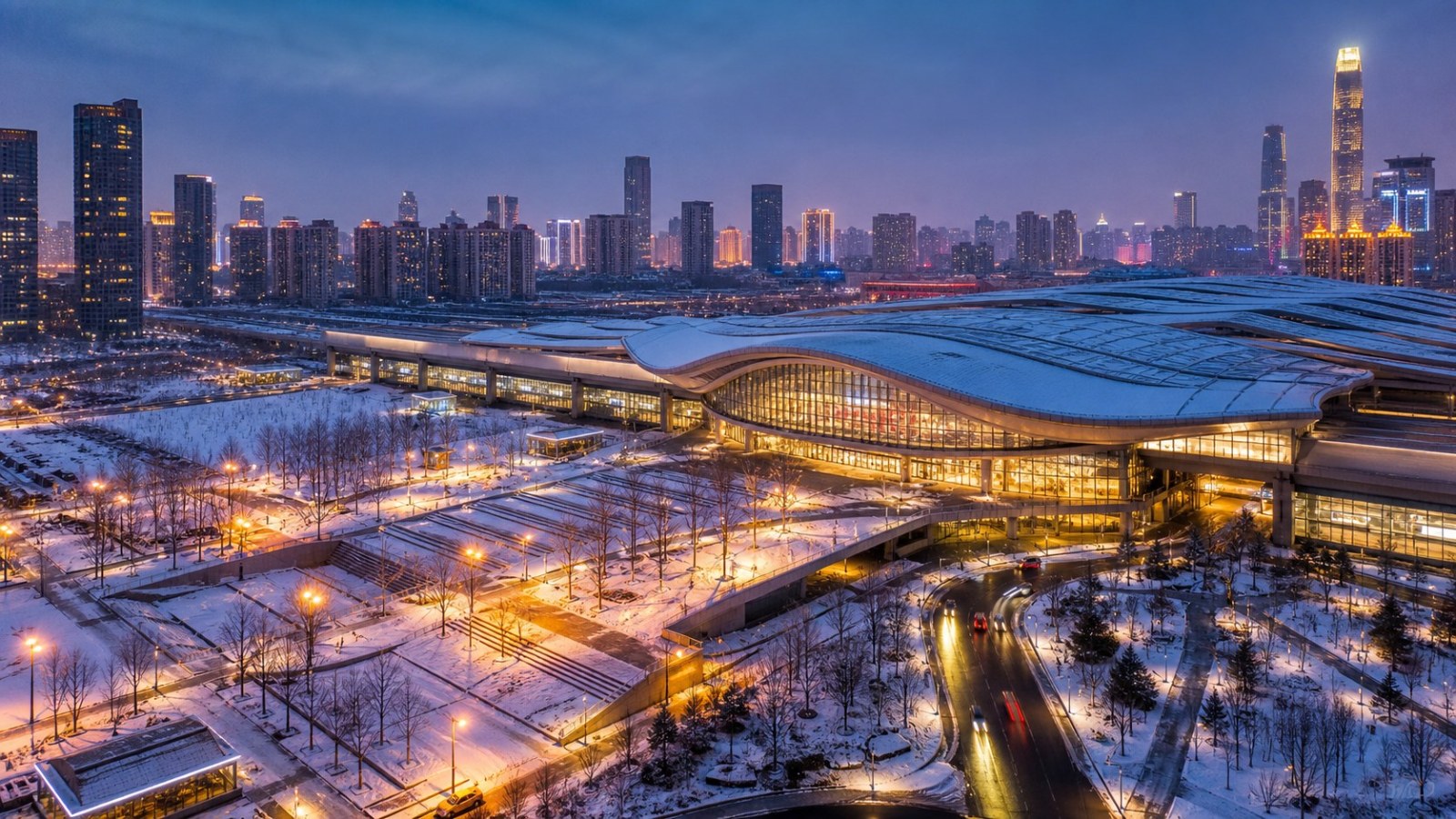 Modern Shenyang transport hub and skyline on a snowy winter evening