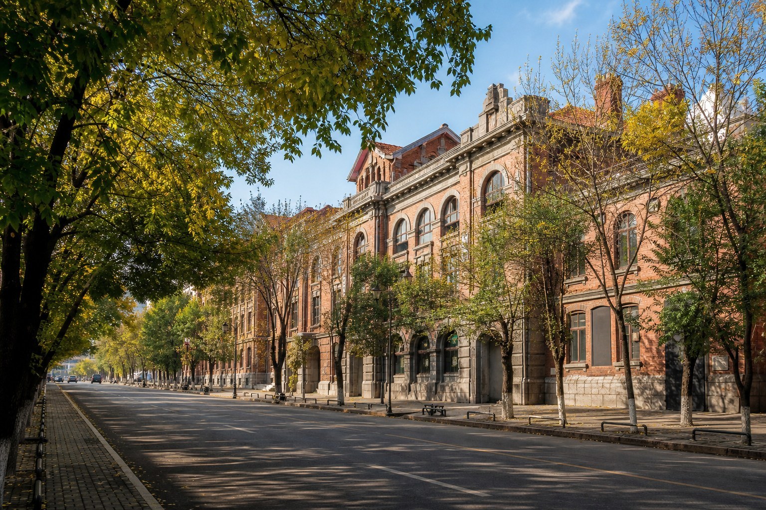 Historic railway-era brick civic buildings on a tree-lined Suifenhe street