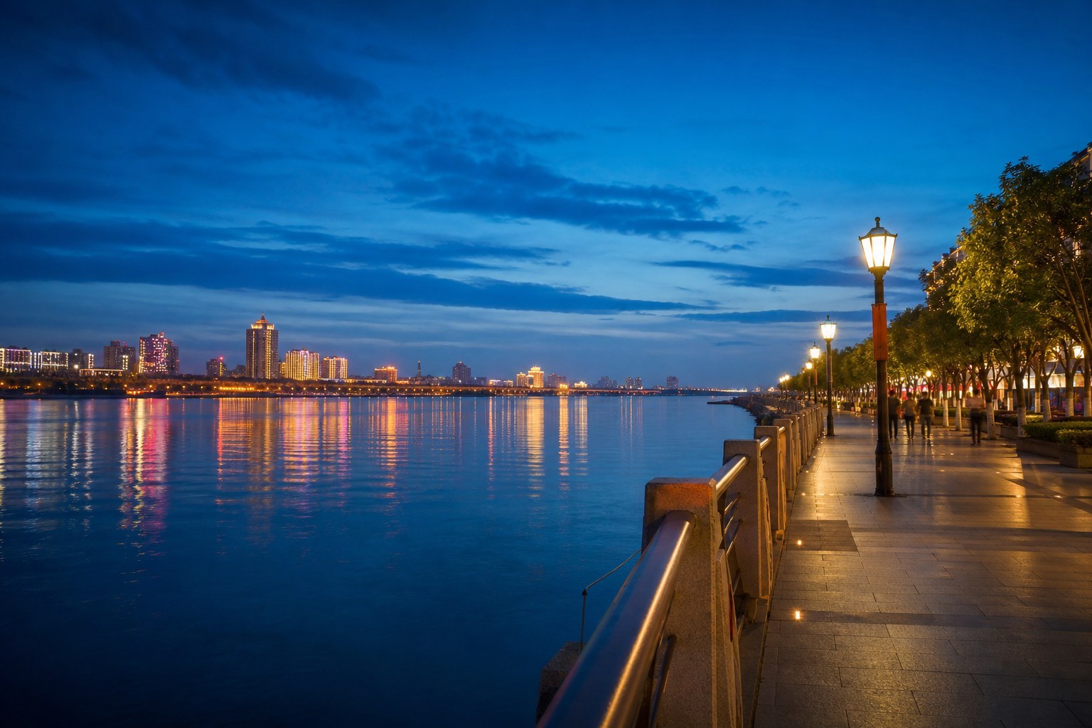Modern Heihe promenade beside the broad Amur River at blue hour