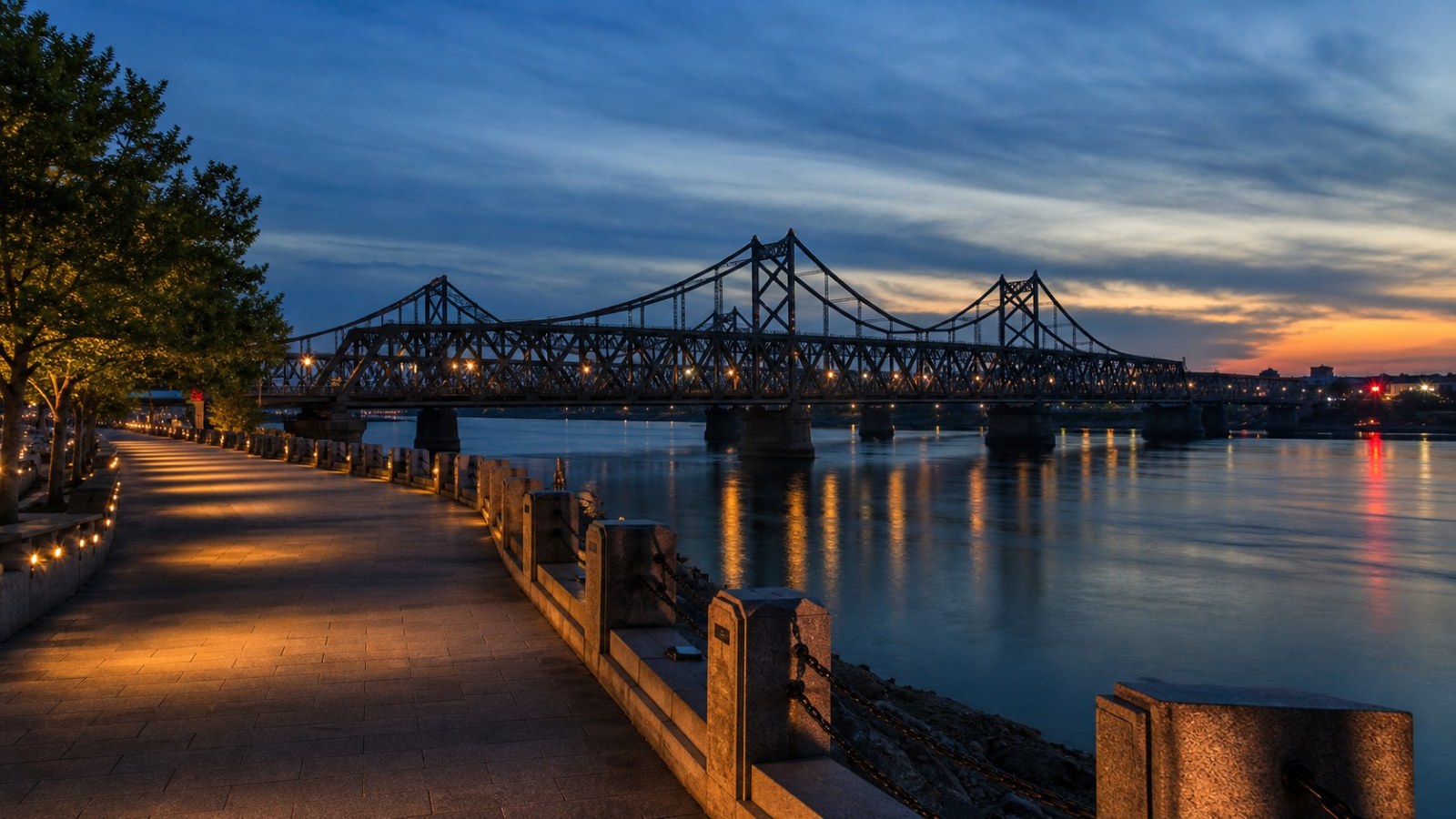 Dandong Yalu River waterfront and Broken Bridge at blue hour