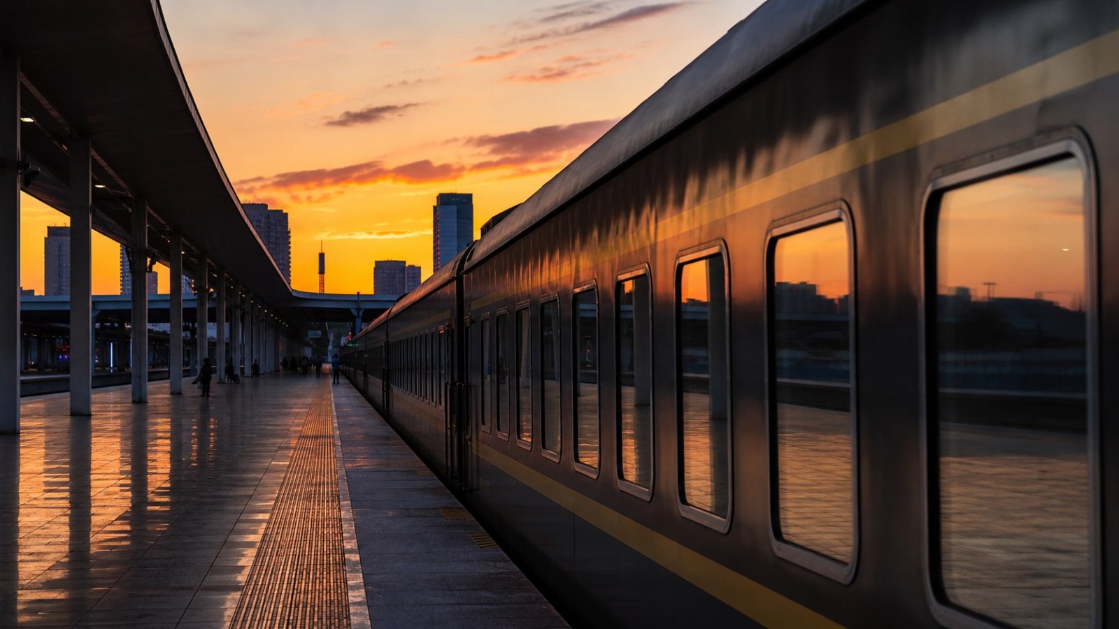 Overnight passenger train at Shenyang railway station during sunset