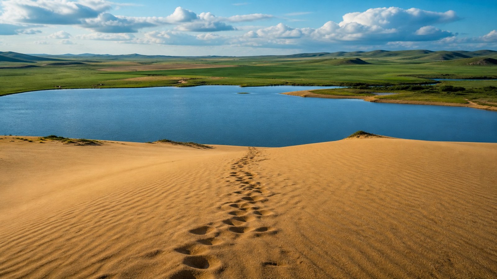 Rippled desert dunes and clear blue water at Yulong Sand Lake on the first day