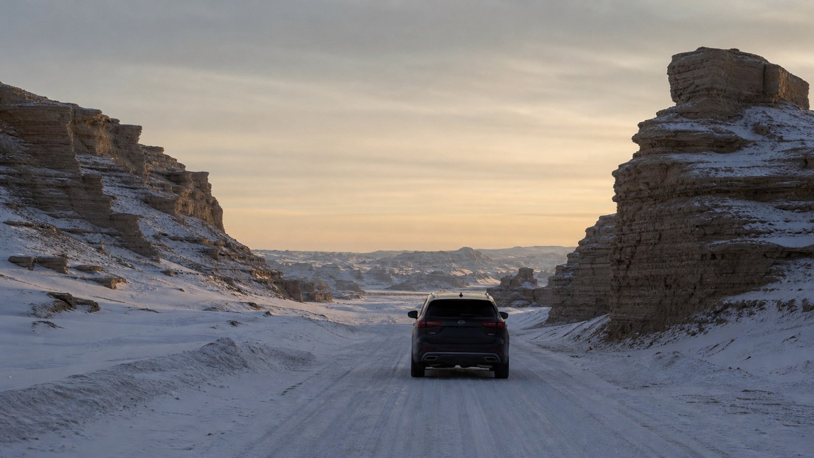 Self-drive vehicle crossing snowy yardang formations from Burqin to Kuitun