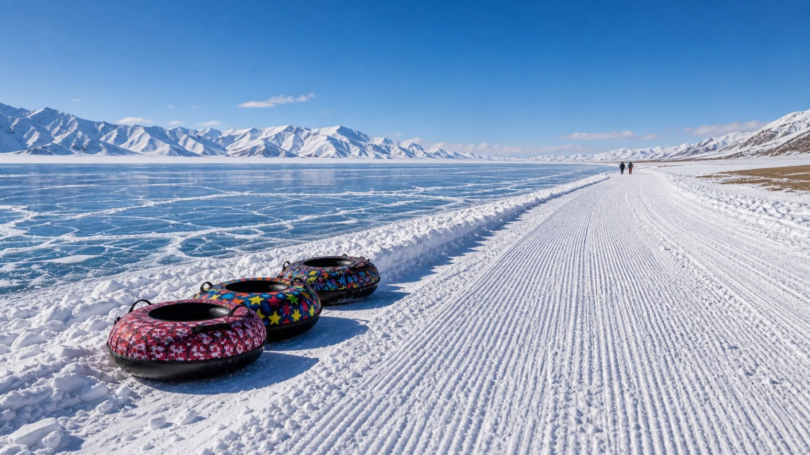 Snow tubes beside a groomed winter activity lane at Sayram Lake