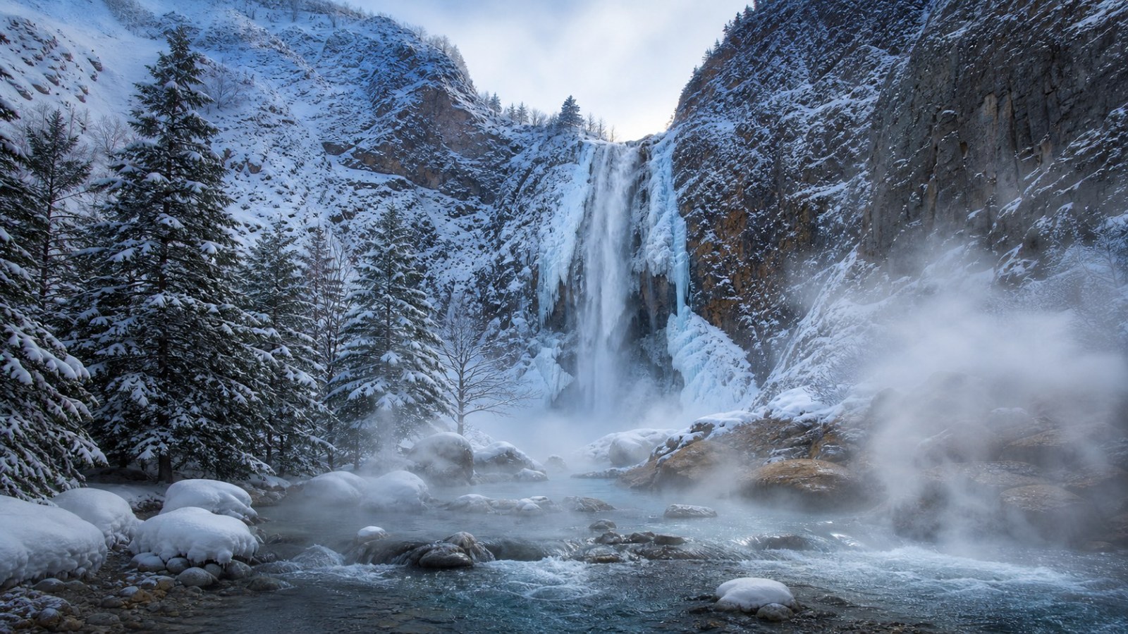 Frozen waterfall and geothermal stream at Changbai Mountain