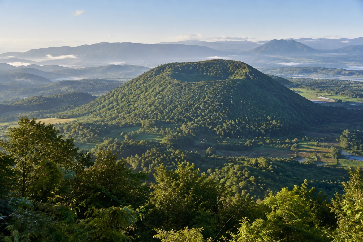 A forested volcanic cone near Tengchong