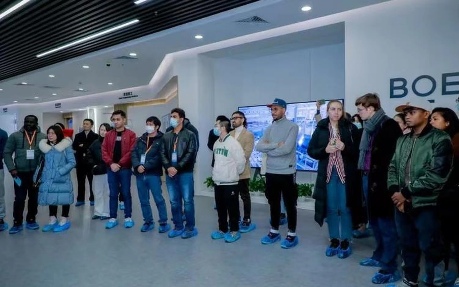 Visitors at an advanced vehicle manufacturing facility in Hefei