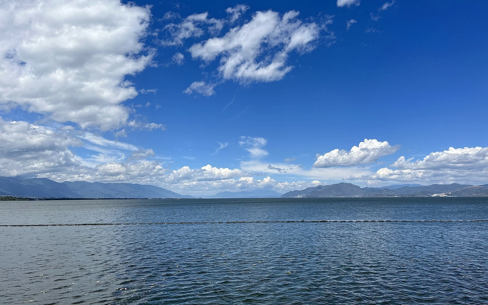 Blue skies over the open water of Erhai Lake