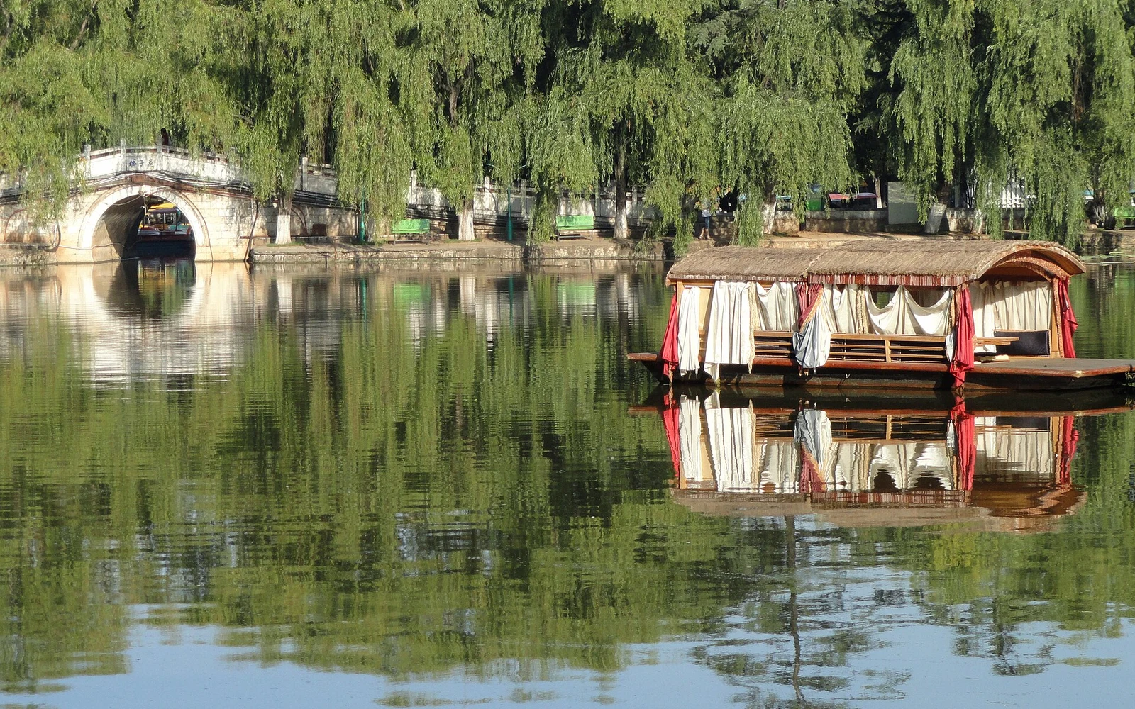 Arched bridge and reflections in Green Lake Park in Kunming