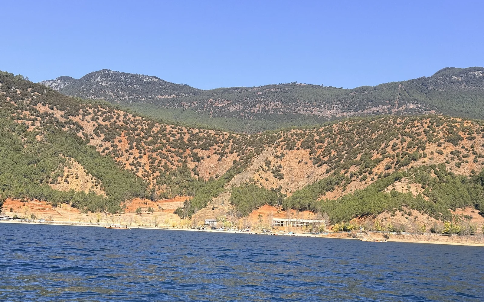 Mountain slopes across the water at Lugu Lake