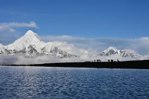Mount Gongga reflected across the lake landscape