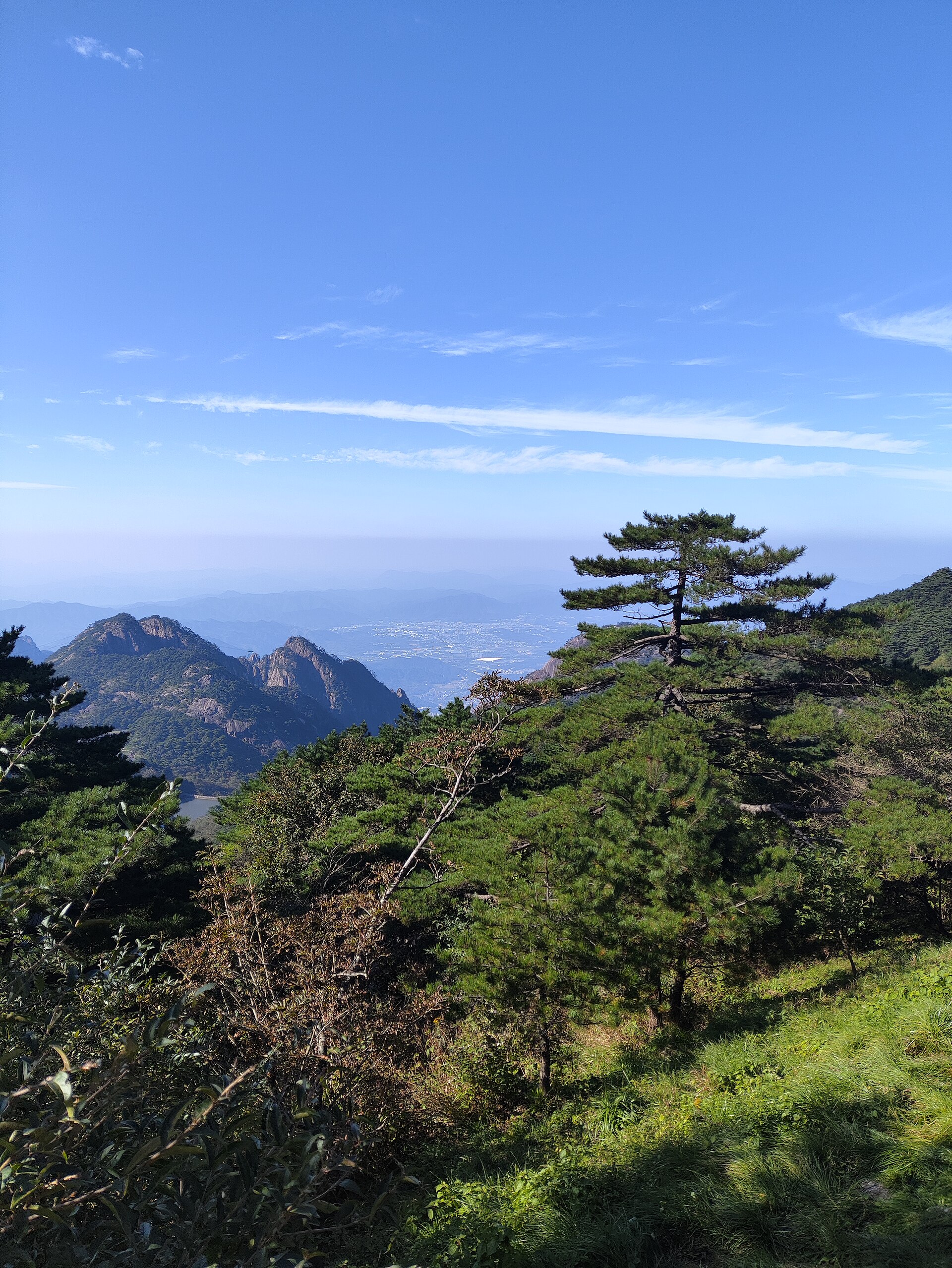Granite ridges and pine trees under a blue sky at Huangshan