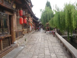 A stone-paved street lined with traditional buildings in Lijiang Old Town