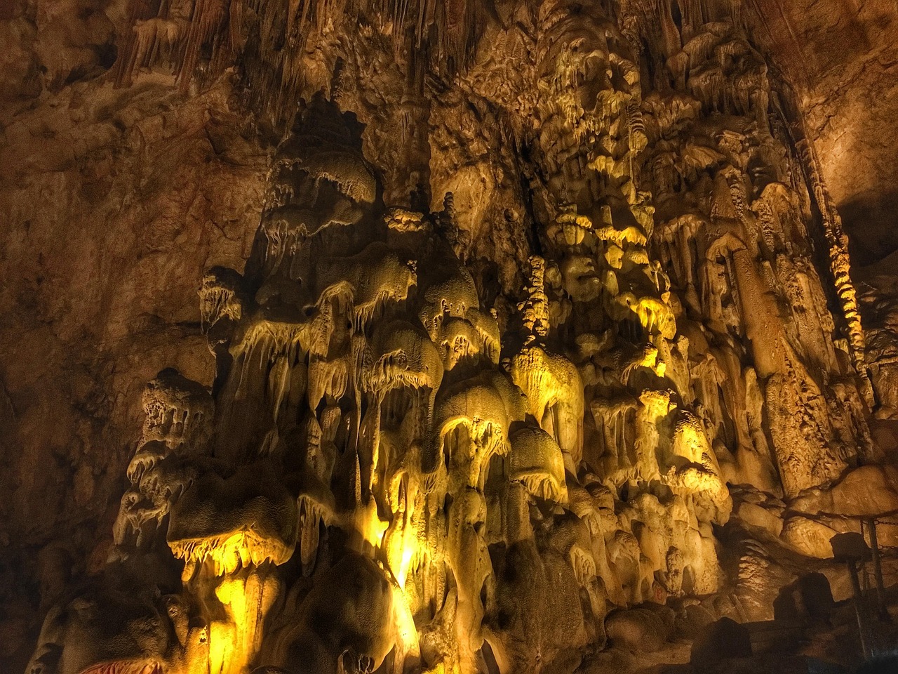 Illuminated limestone formations inside Zhijin Cave in Guizhou